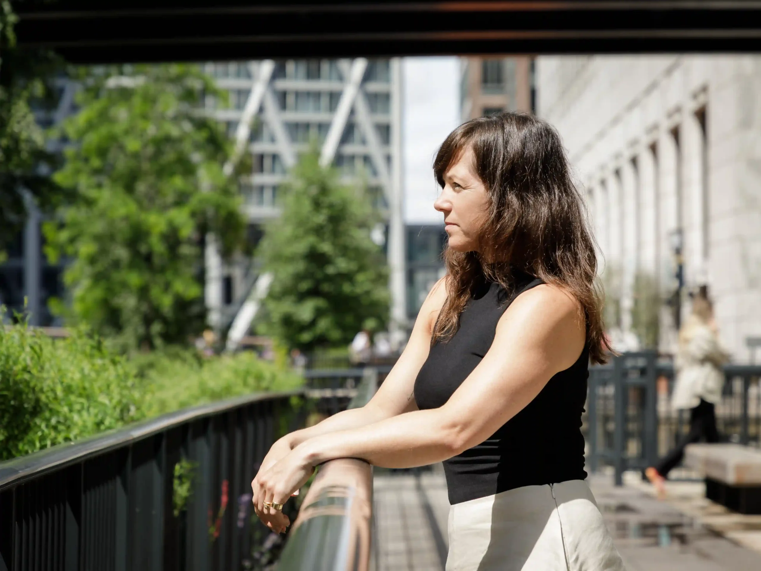 Laura Mai leaning on a rail overlooking greenery